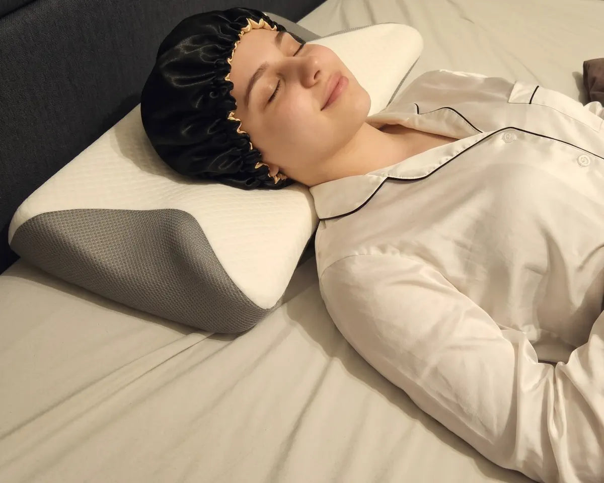 The same person lying on their back, the back of the head resting in the pillow's hollow.